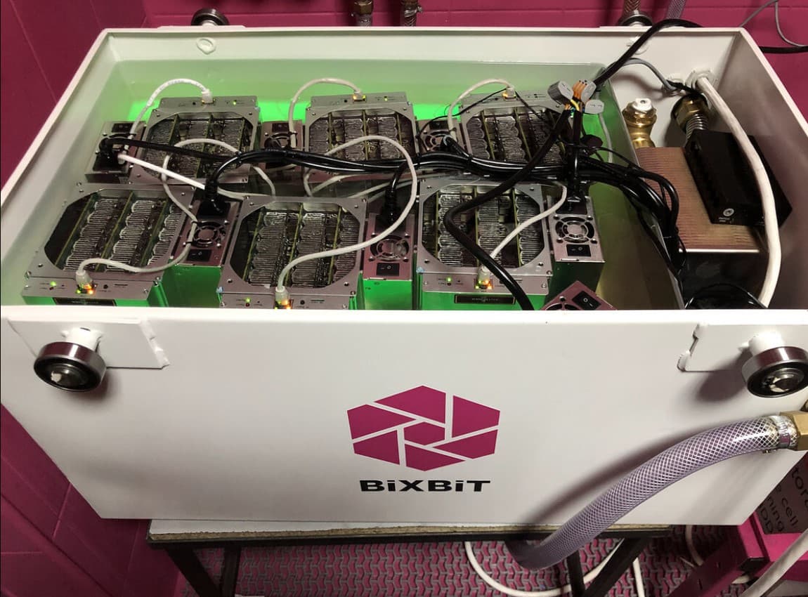An open immersion-cooling tank with miners submerged in liquid